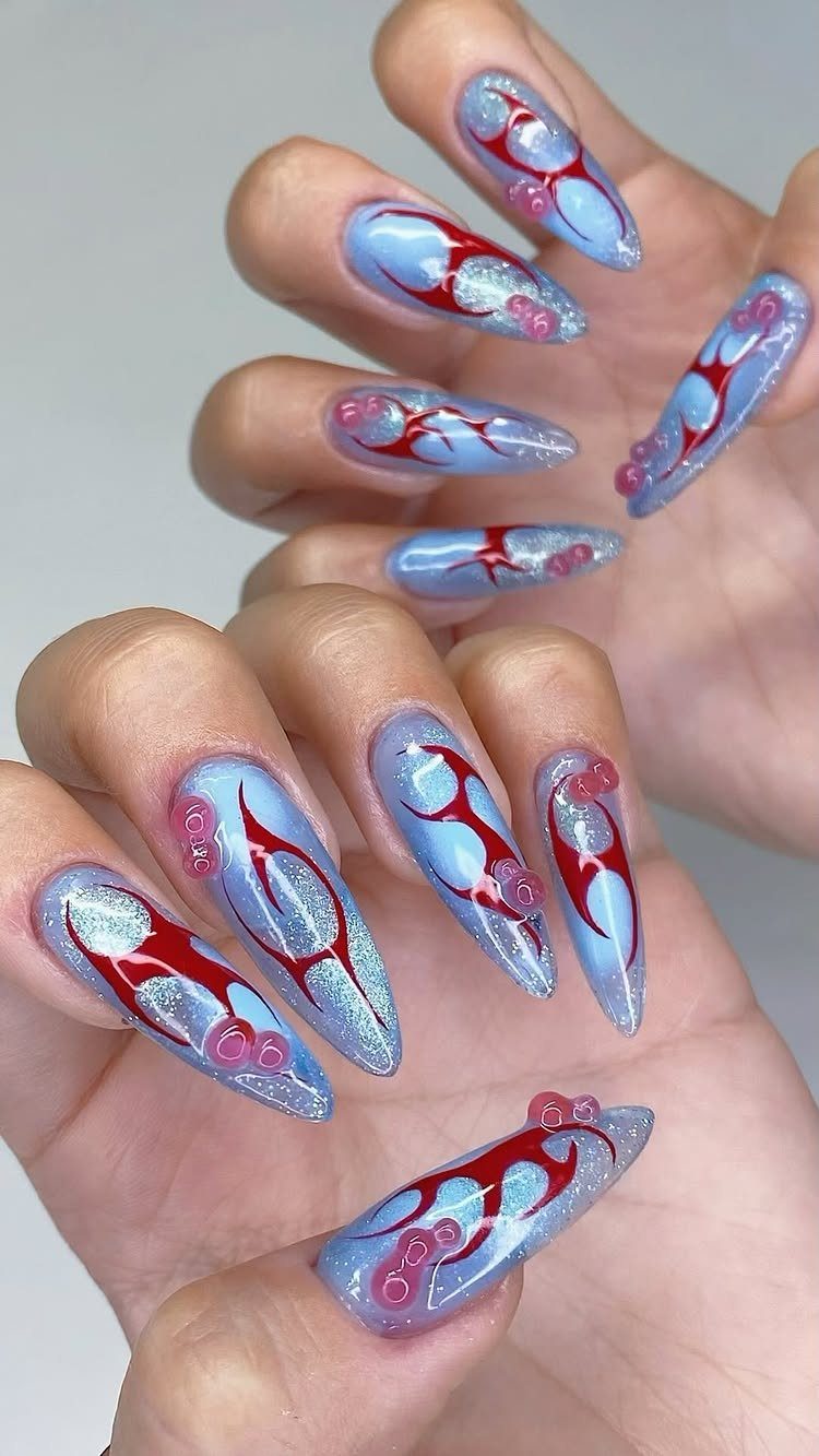 Long almond nails with light blue chrome finish and red flame designs