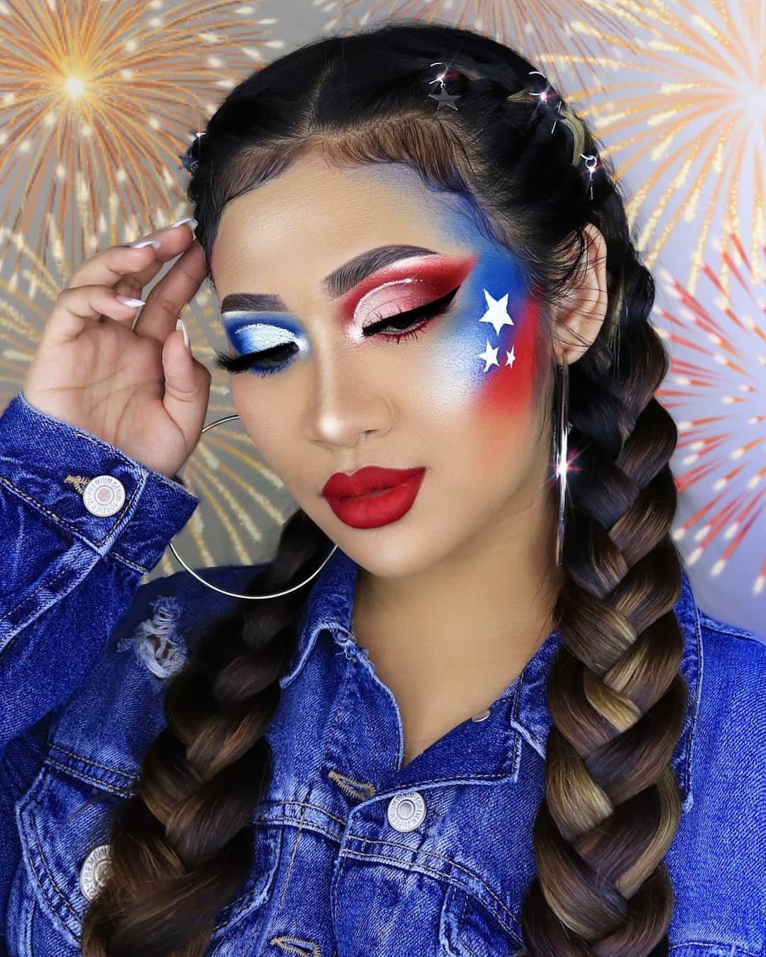 Woman with patriotic red, white, and blue makeup and white star cheek decals.