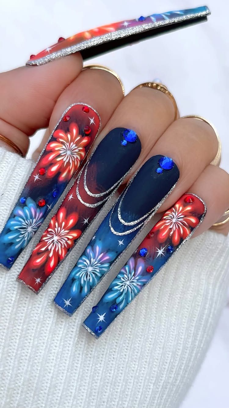 Long coffin nails with red, white, and blue fireworks and sparkling rhinestones.