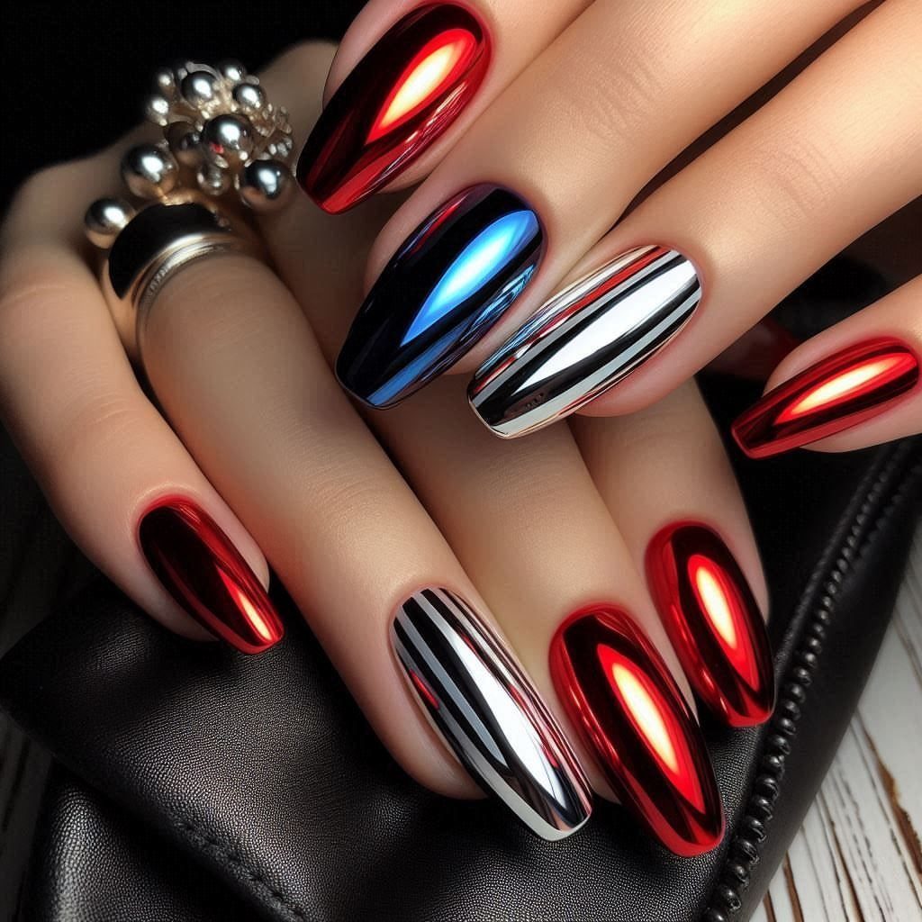 Metallic chrome nails in red, blue, and silver on a hand holding a clutch.