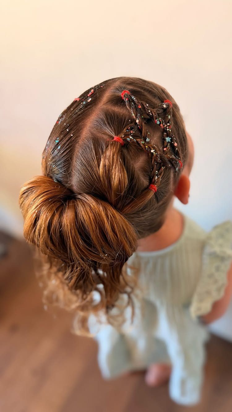 Child's brown hair in a ponytail with a star shape and patriotic glitter.