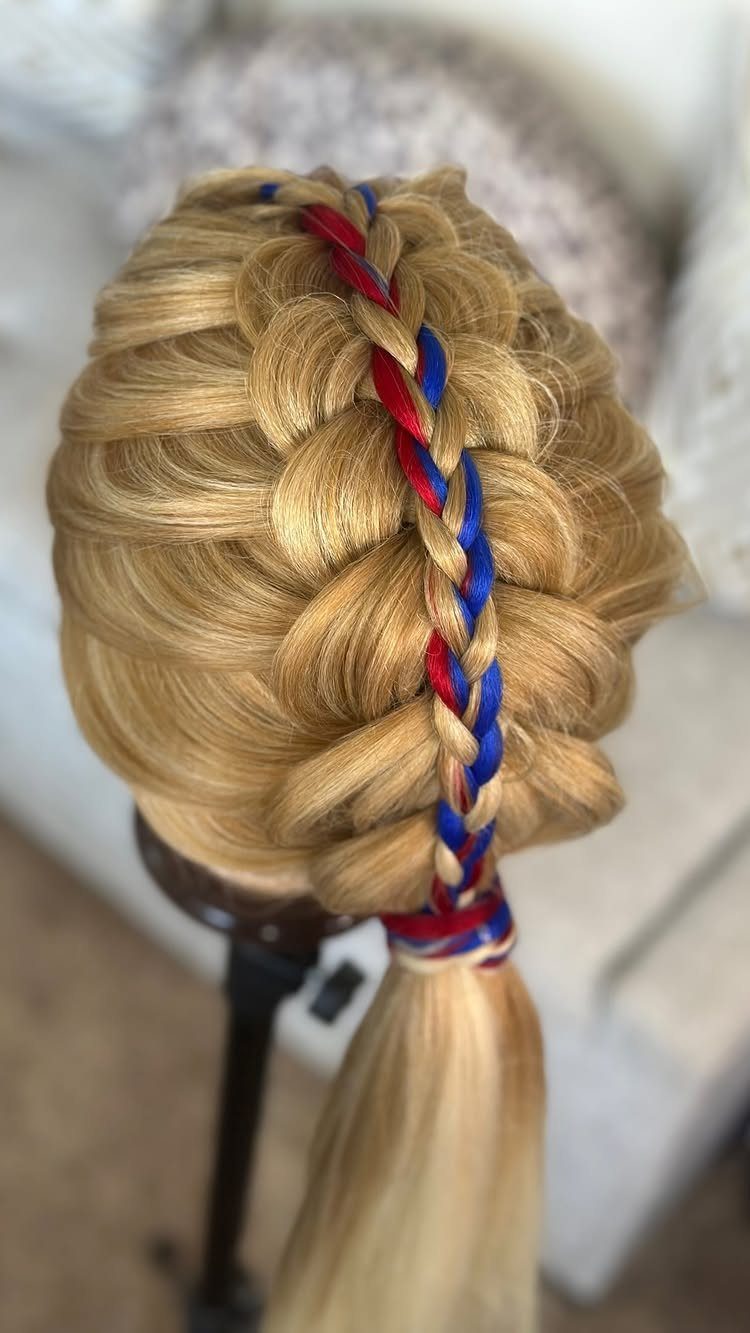 Blonde hair braided with red and blue ribbons on a mannequin head