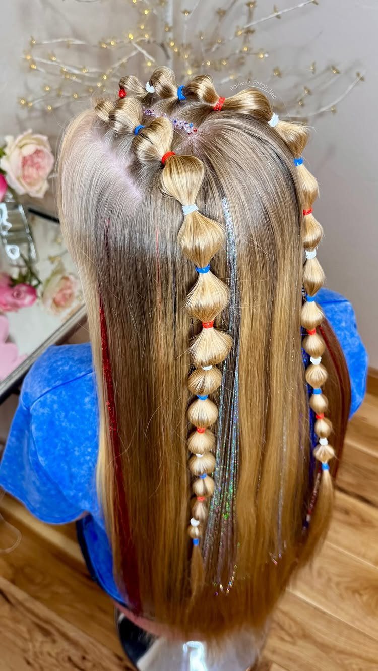 Blonde hair with bubble braids and red, white, and blue hair extensions.