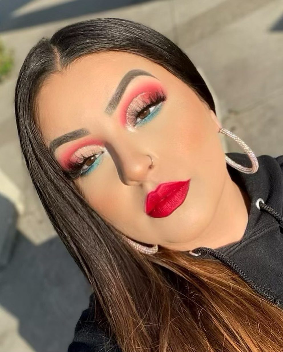 Woman wearing red, white, and blue patriotic eyeshadow and bold red lipstick.