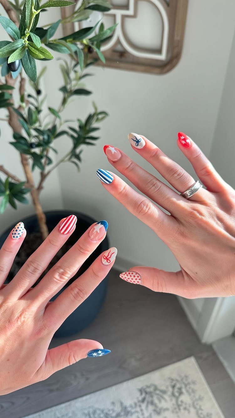 Acrylic nails with red, white, and blue patriotic patterns, stripes, and stars.