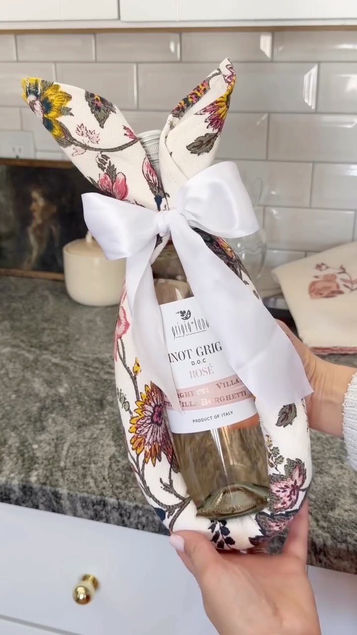 Bottle of wine wrapped in floral fabric to look like an Easter bunny