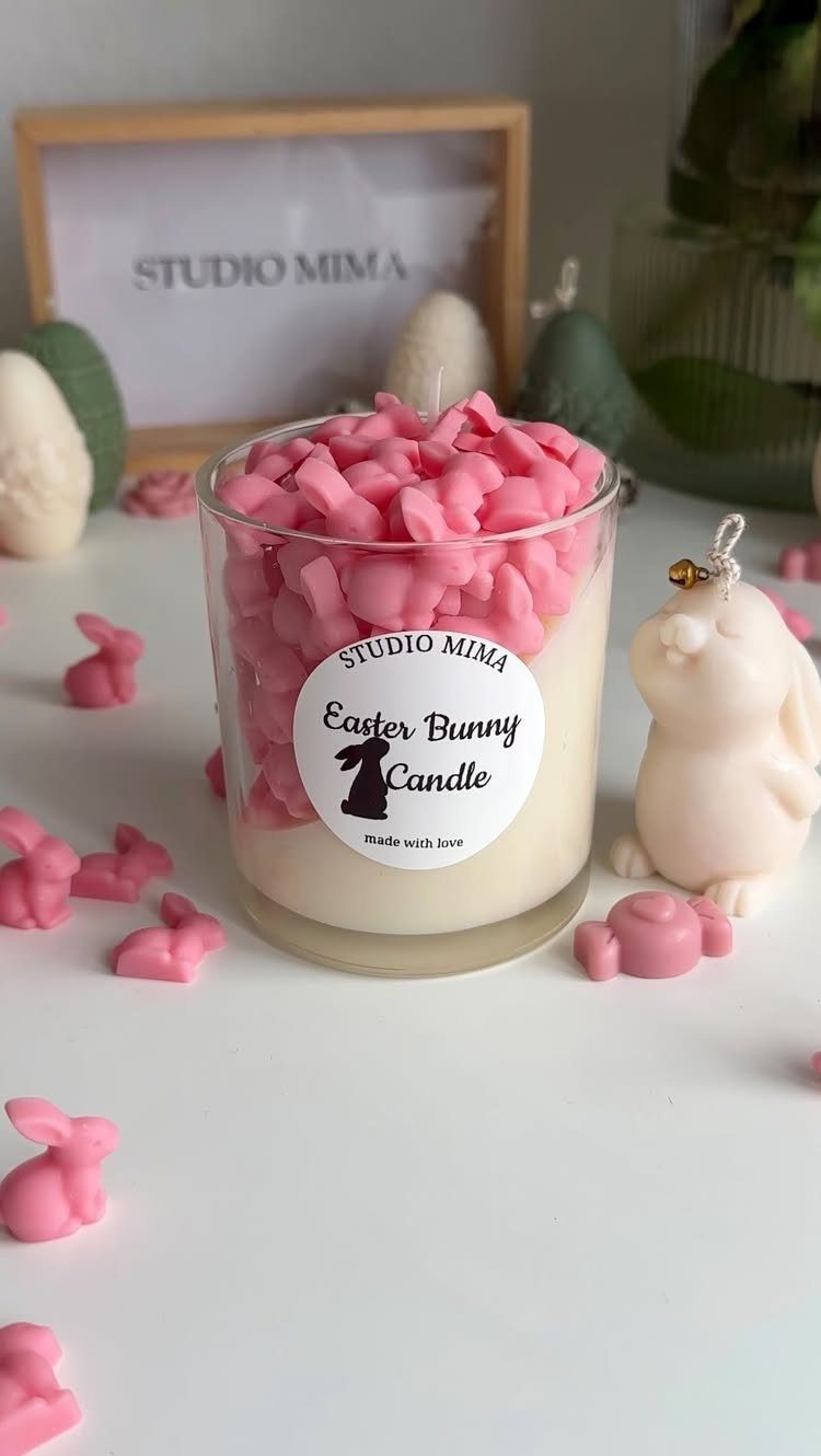 Easter bunny candle in a glass jar topped with pink wax bunnies
