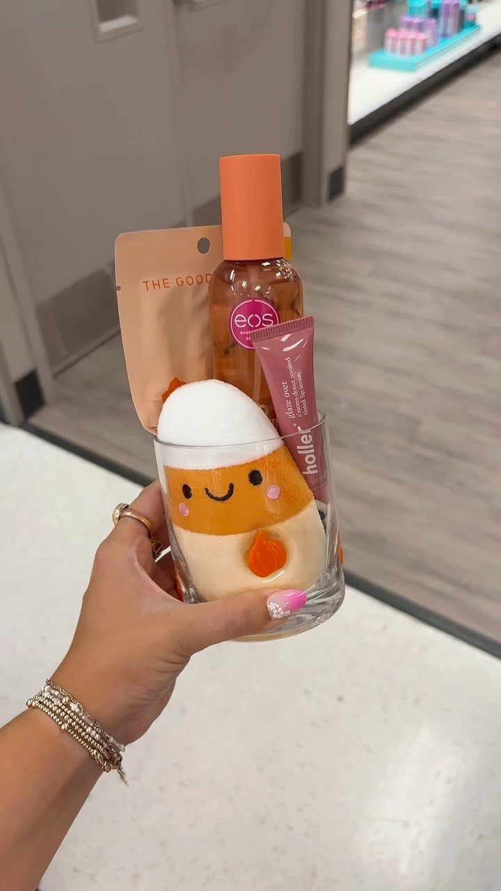 Chick-shaped glass used as an Easter basket filled with various beauty products.