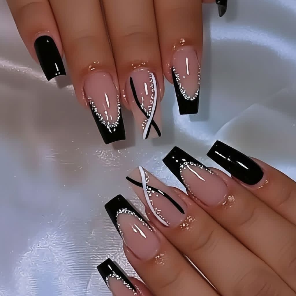 Long coffin nails with black French tips and silver glitter accents on white satin.