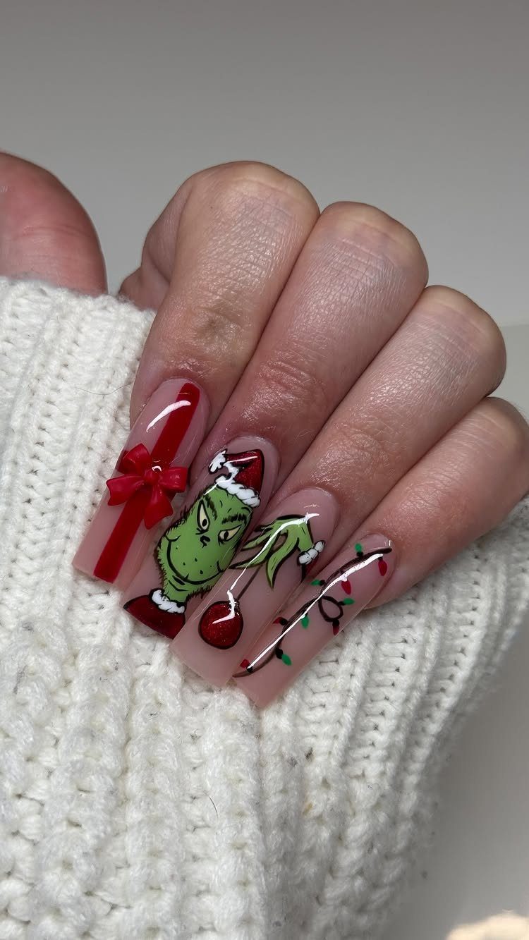 Festive coffin nails featuring the Grinch, red ribbons, and colorful Christmas lights.