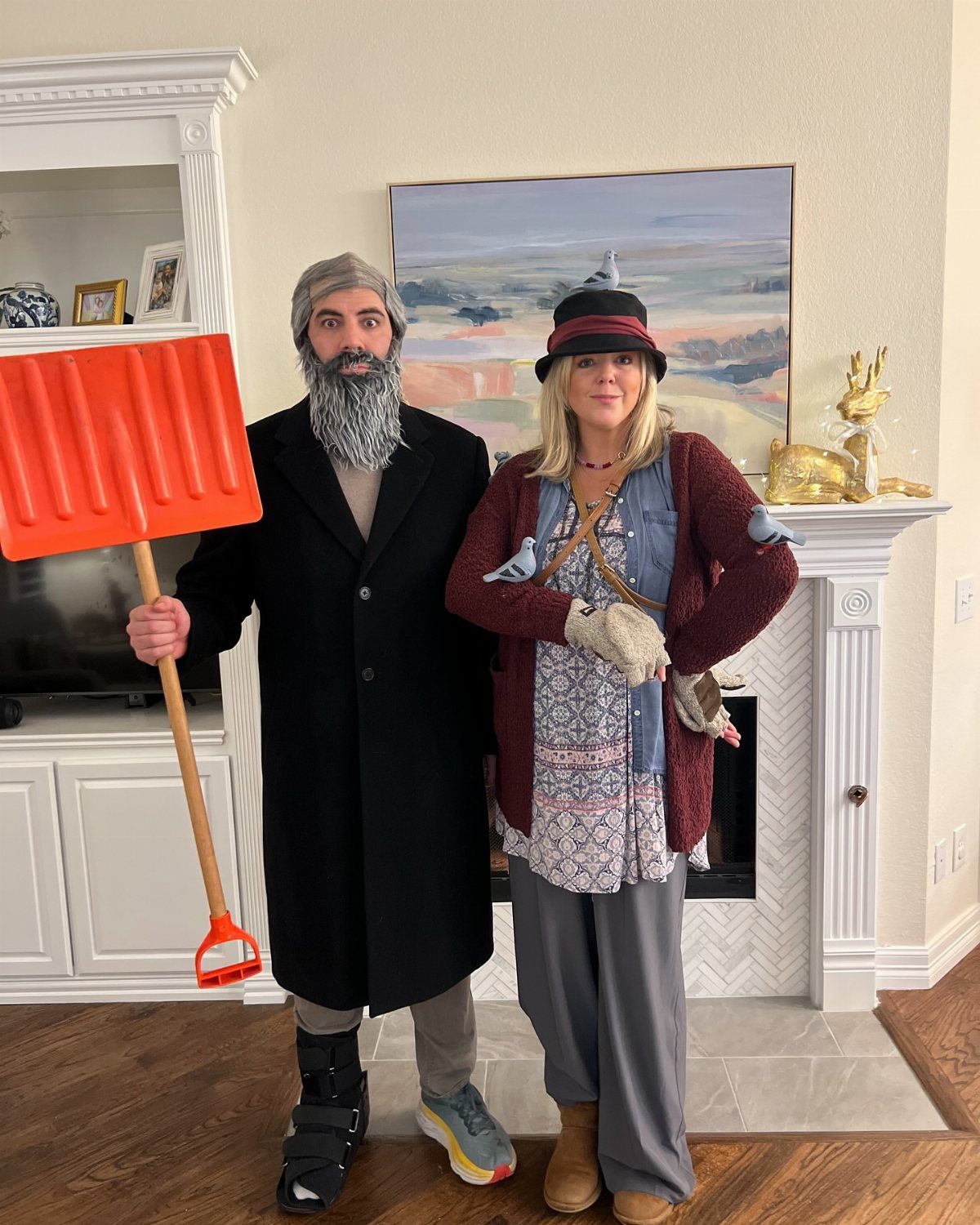 Man and woman dressed as characters from a Christmas movie posing in a living room