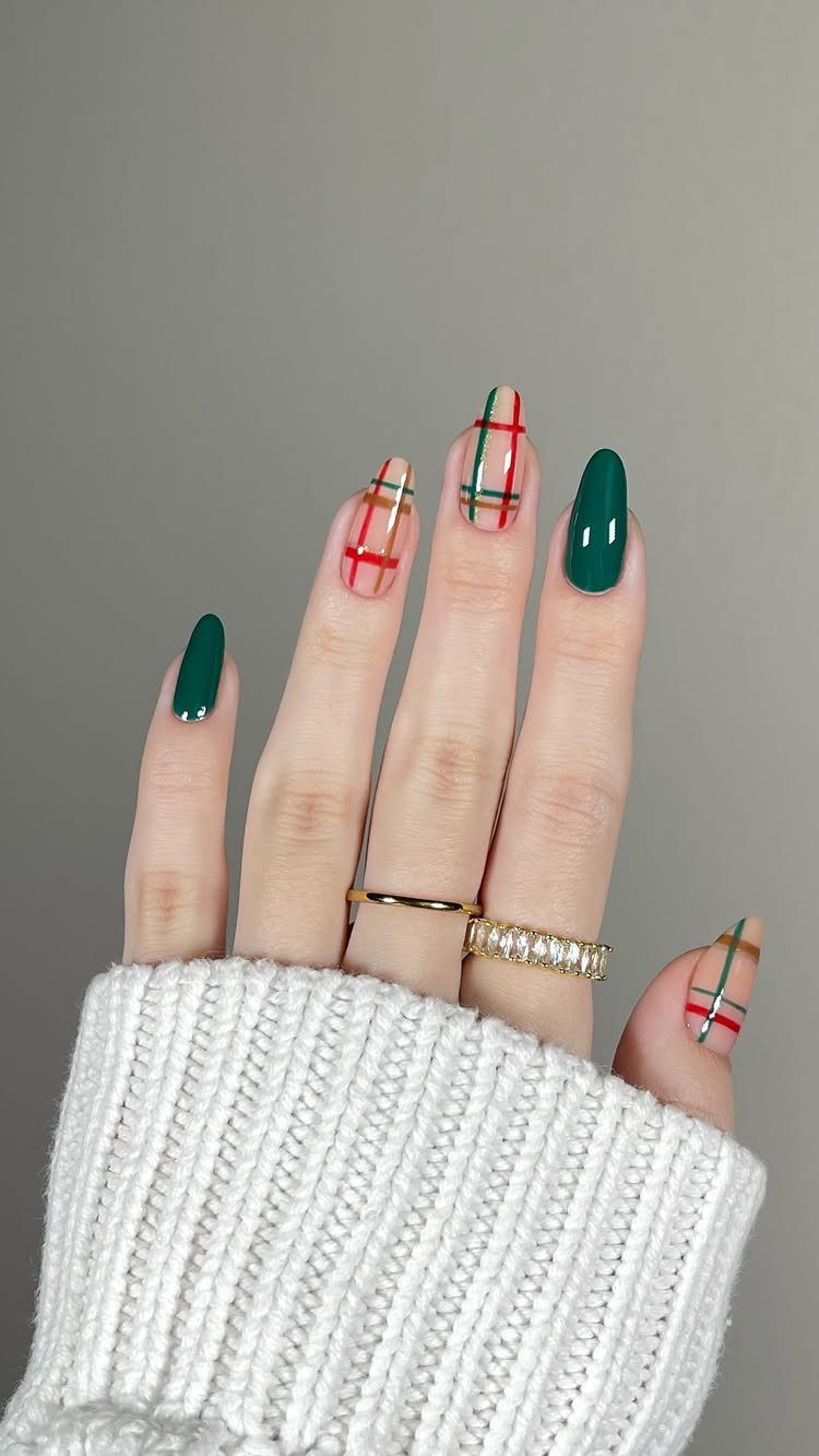 Hand with red and green plaid and solid green holiday nail art