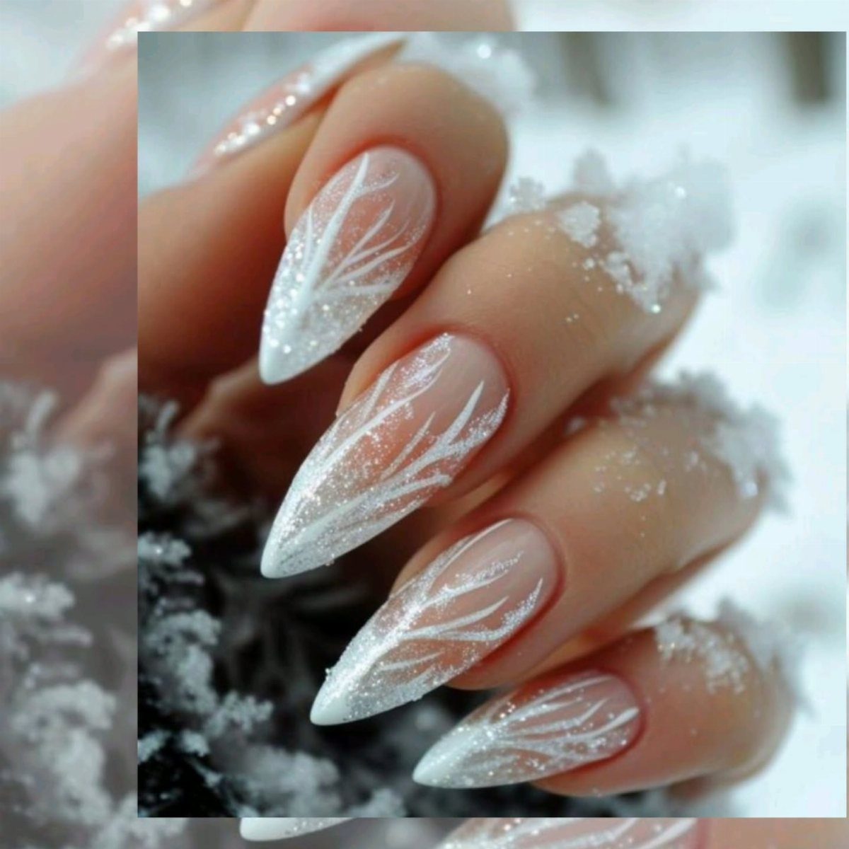 Almond-shaped nails with white winter branch art covered in fresh white snow.