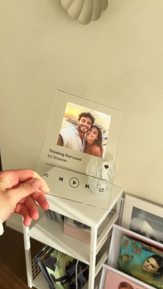 Acrylic song plaque with a couple's photo and music player interface on shelf