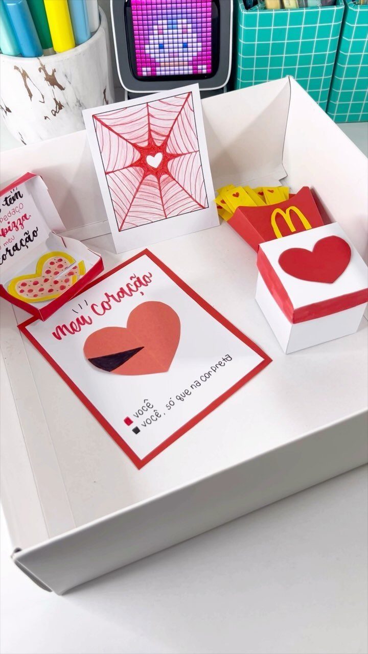 Handmade romantic gift box with heart-themed cards and small decorative boxes.