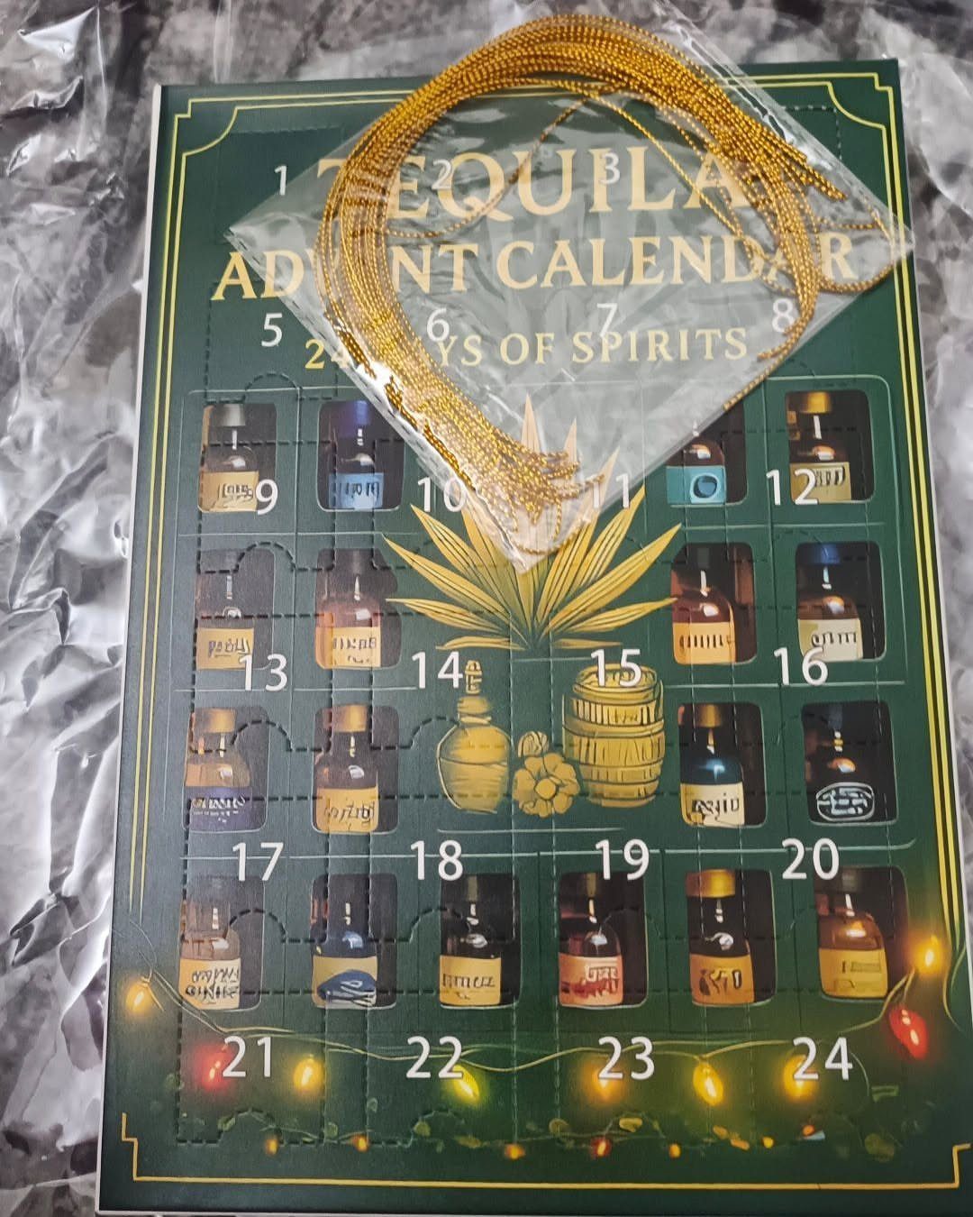 Tequila Advent Calendar box with numbered spirit bottles and a gold ribbon.
