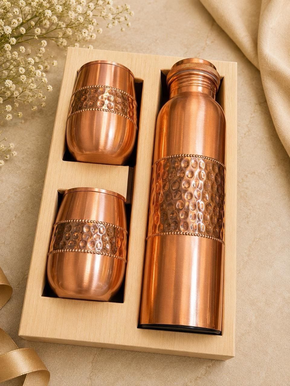 Copper water bottle and two tumblers in a light wooden gift box