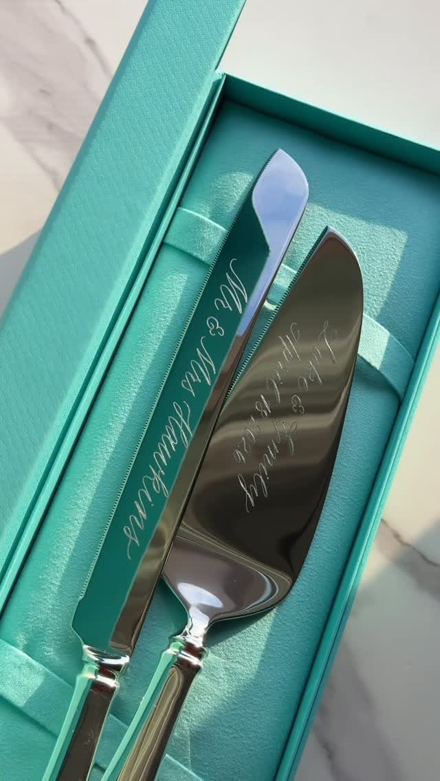 Engraved silver cake server and knife set in a teal blue gift box.
