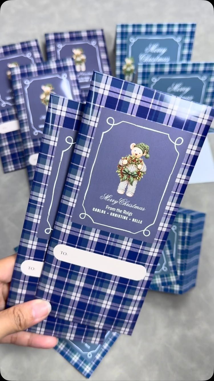 Blue plaid Christmas cards and envelopes with a teddy bear and personalized names.