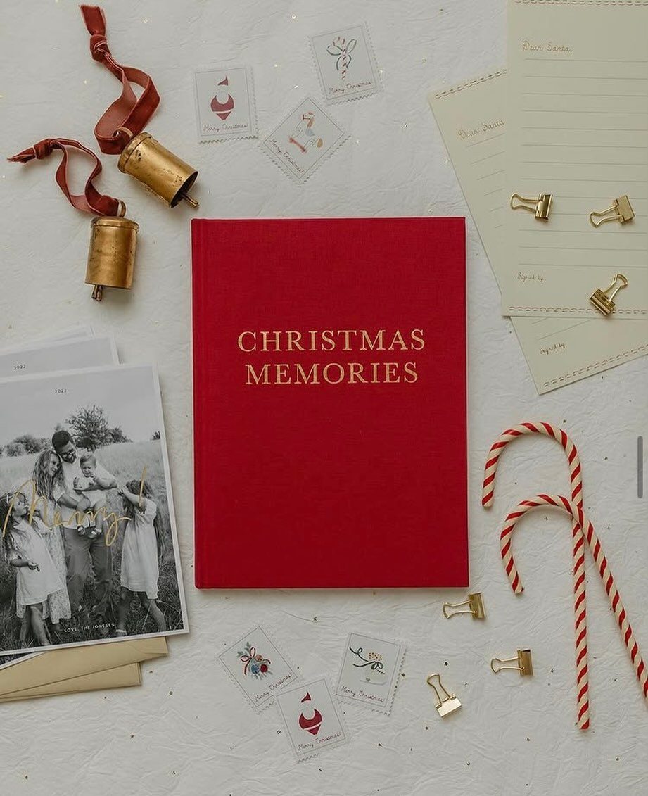 Red Christmas Memories book surrounded by candy canes, gold bells, and family photos.