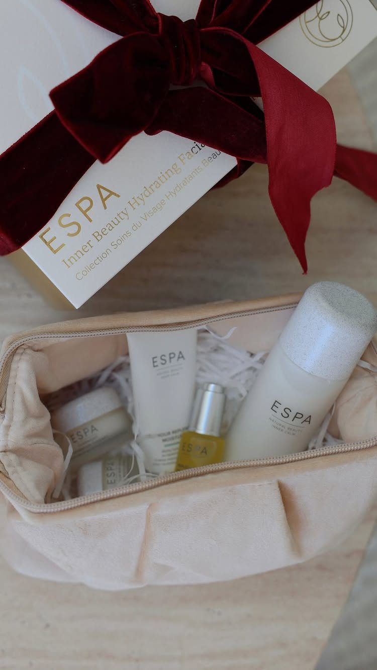 ESPA skincare gift set in a beige pouch with a red velvet bow.