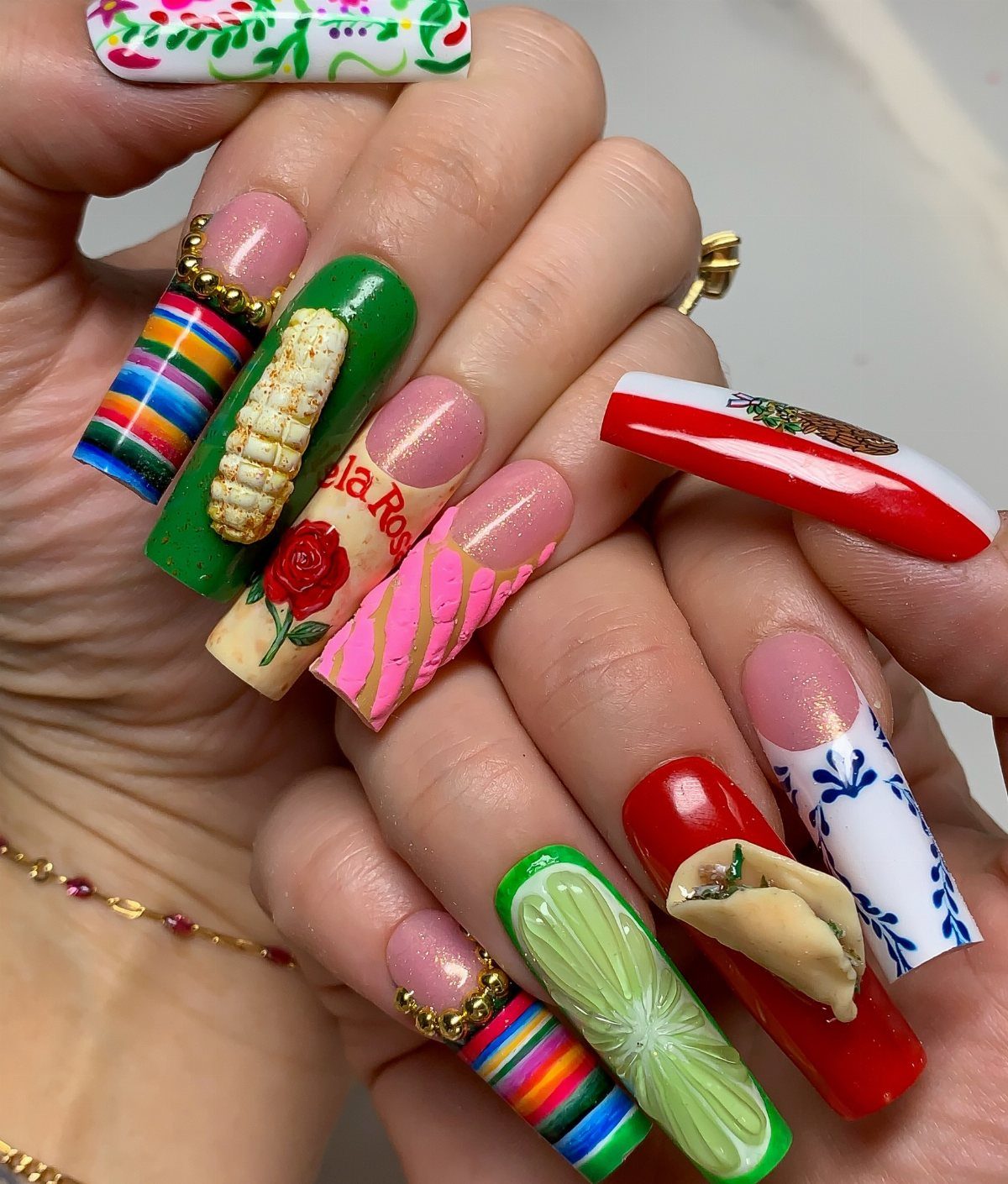 Long coffin nails featuring 3D taco, corn, lime, and colorful Mexican-themed art.