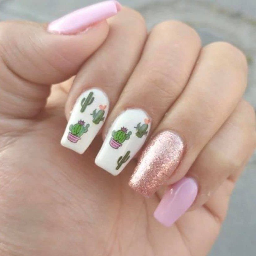 Manicured nails featuring green cactus art on white, rose gold glitter, and pink.