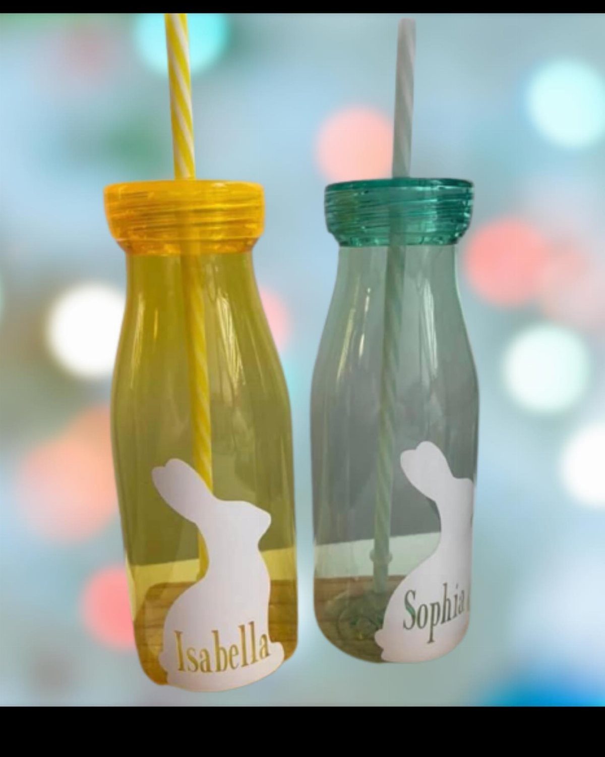 Two reusable water bottles with bunny decals and names, one yellow and one teal.