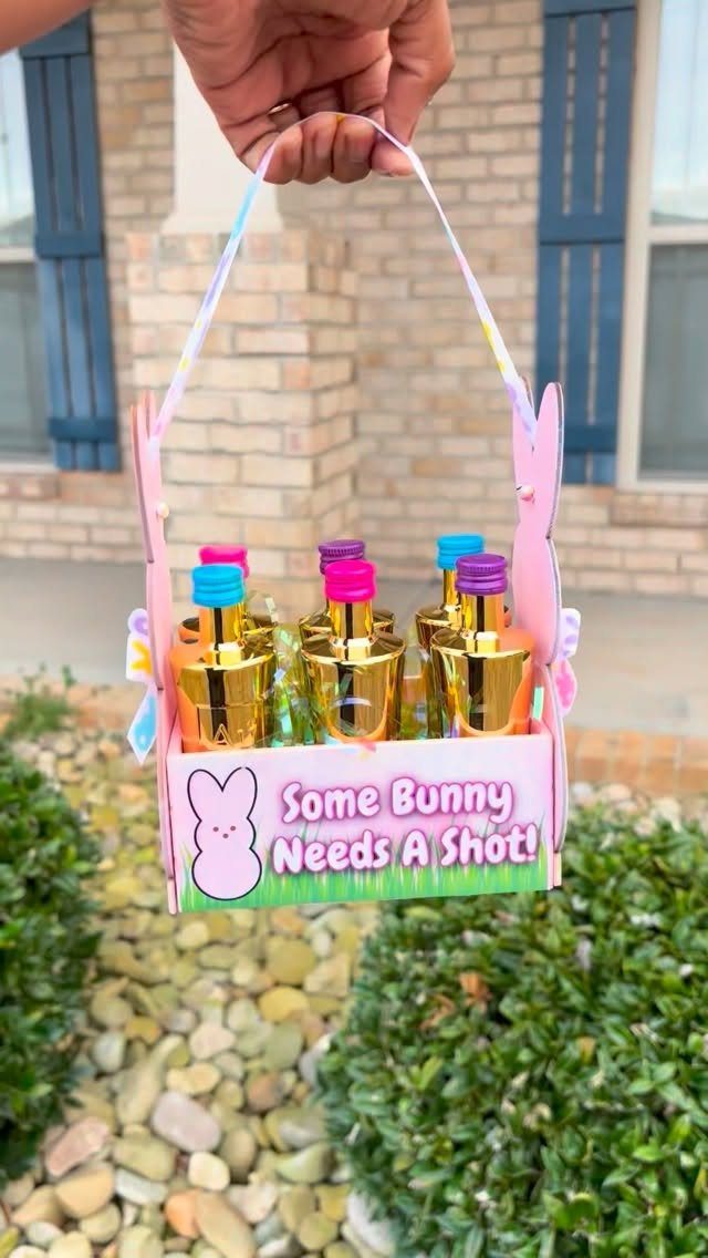 Pink Easter basket filled with mini gold liquor bottles and a punny sign.
