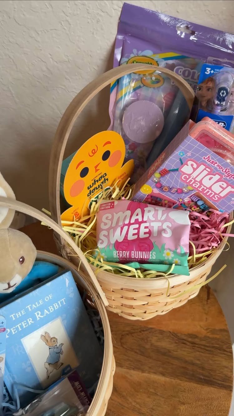 Wicker Easter basket filled with colorful candy and toys on a wooden surface