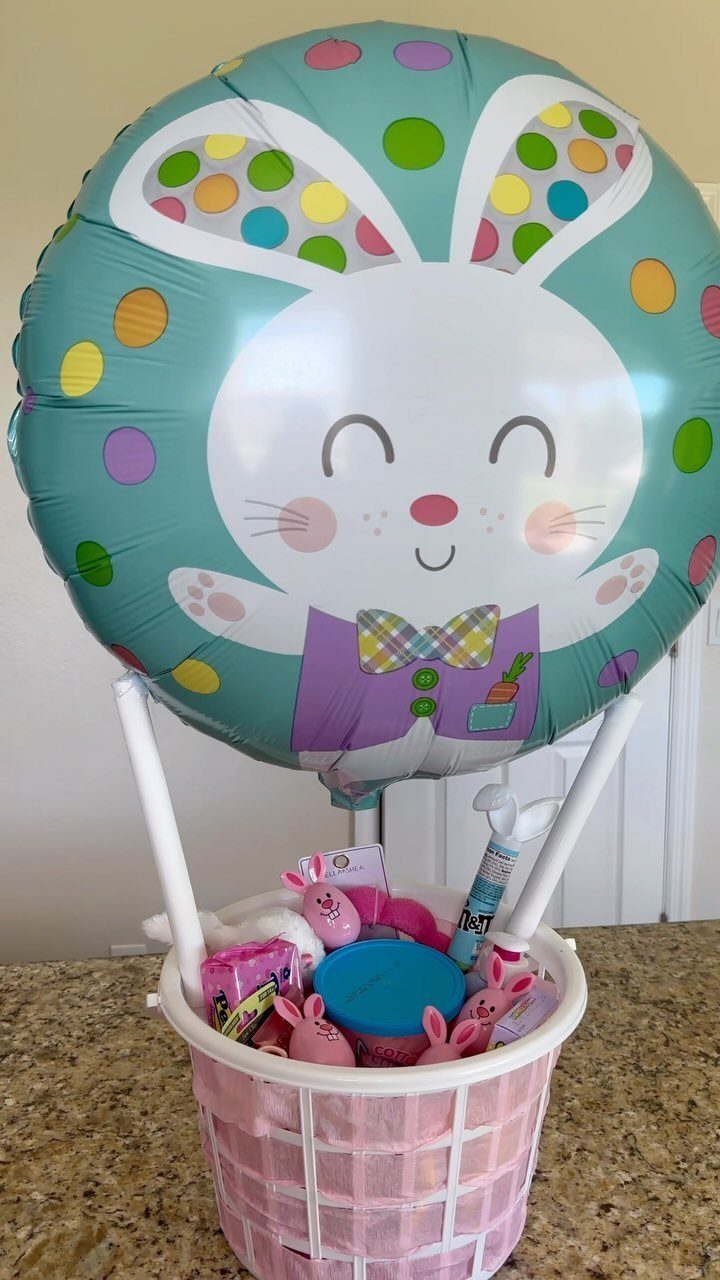 Easter basket with pink liner and a large smiling bunny foil balloon