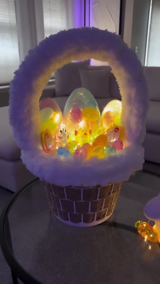 Glowing colorful Easter eggs inside a white fluffy brown woven basket on a table