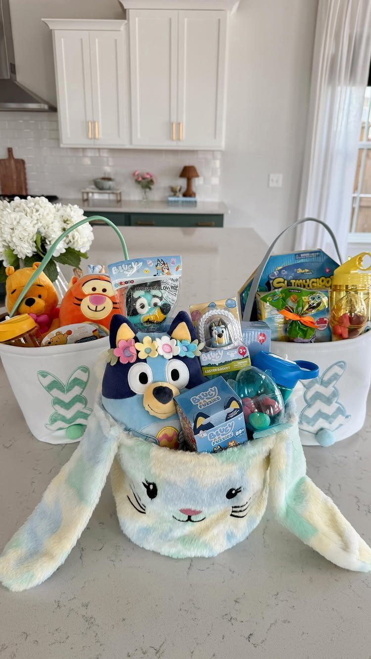 Three white Easter baskets filled with colorful toys and plushies on a kitchen counter