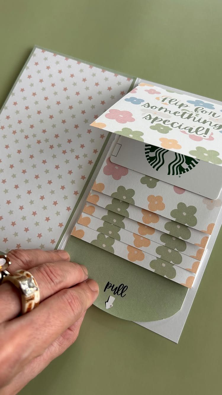 Handmade card with a pull tab revealing a Starbucks gift card and floral accents.