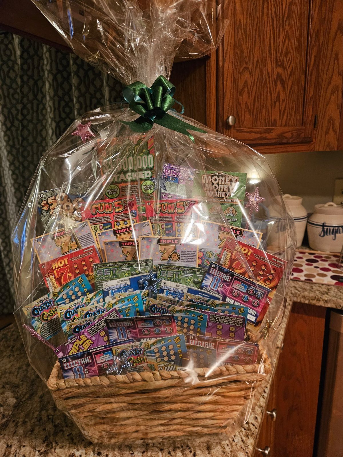Wicker basket filled with colorful scratch-off lottery tickets wrapped in clear cellophane.