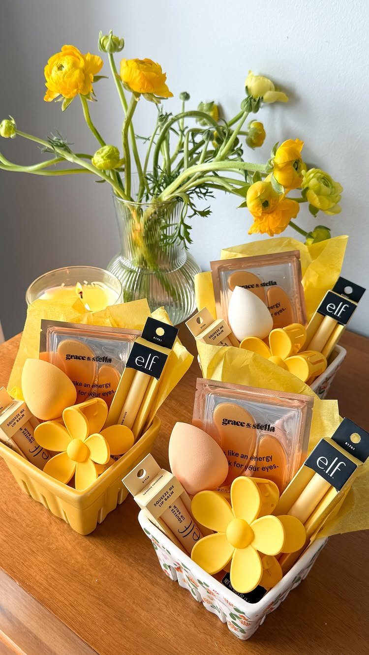 Three yellow Easter baskets filled with skincare and makeup products and yellow flowers.