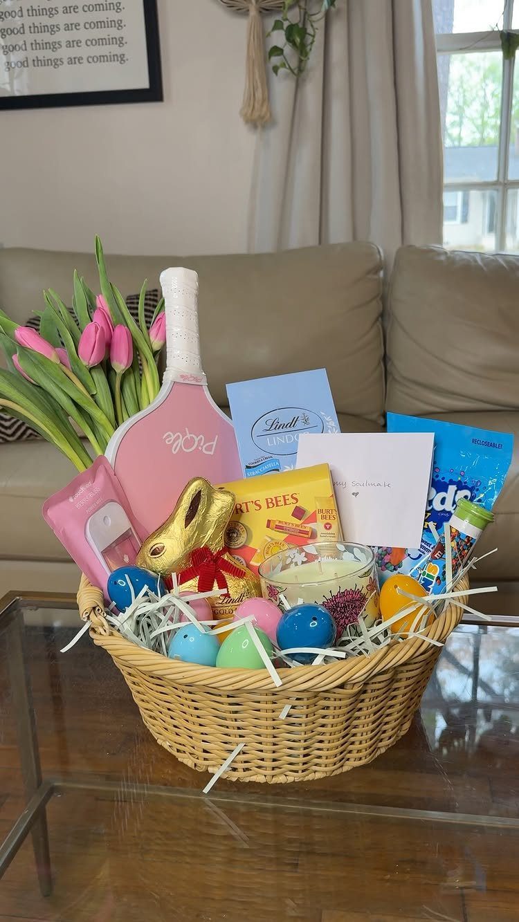 Wicker Easter basket filled with pink tulips, pickleball paddle, and colorful treats.