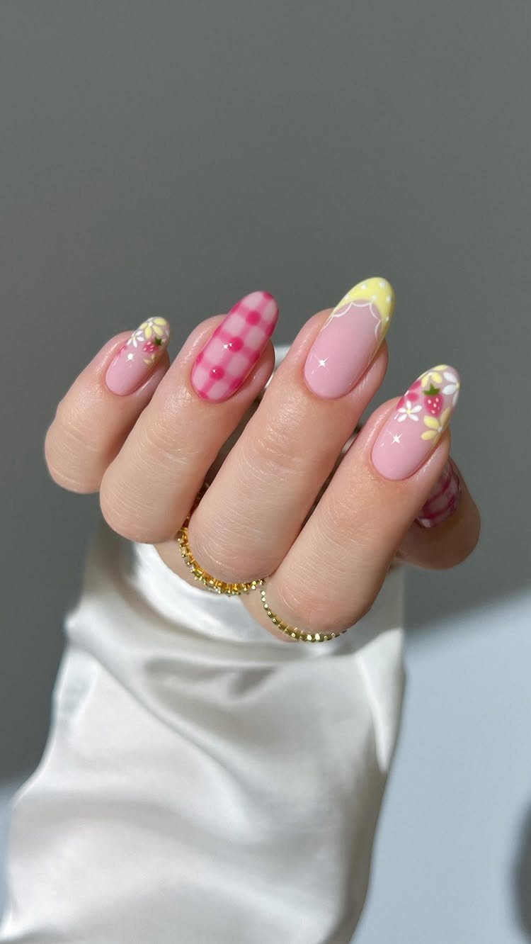 Pastel almond nails with floral accents, gingham patterns, and yellow drip details.