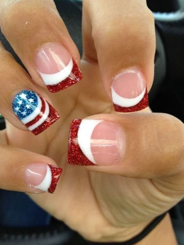 Nails with red glitter and white French tips and one American flag design.