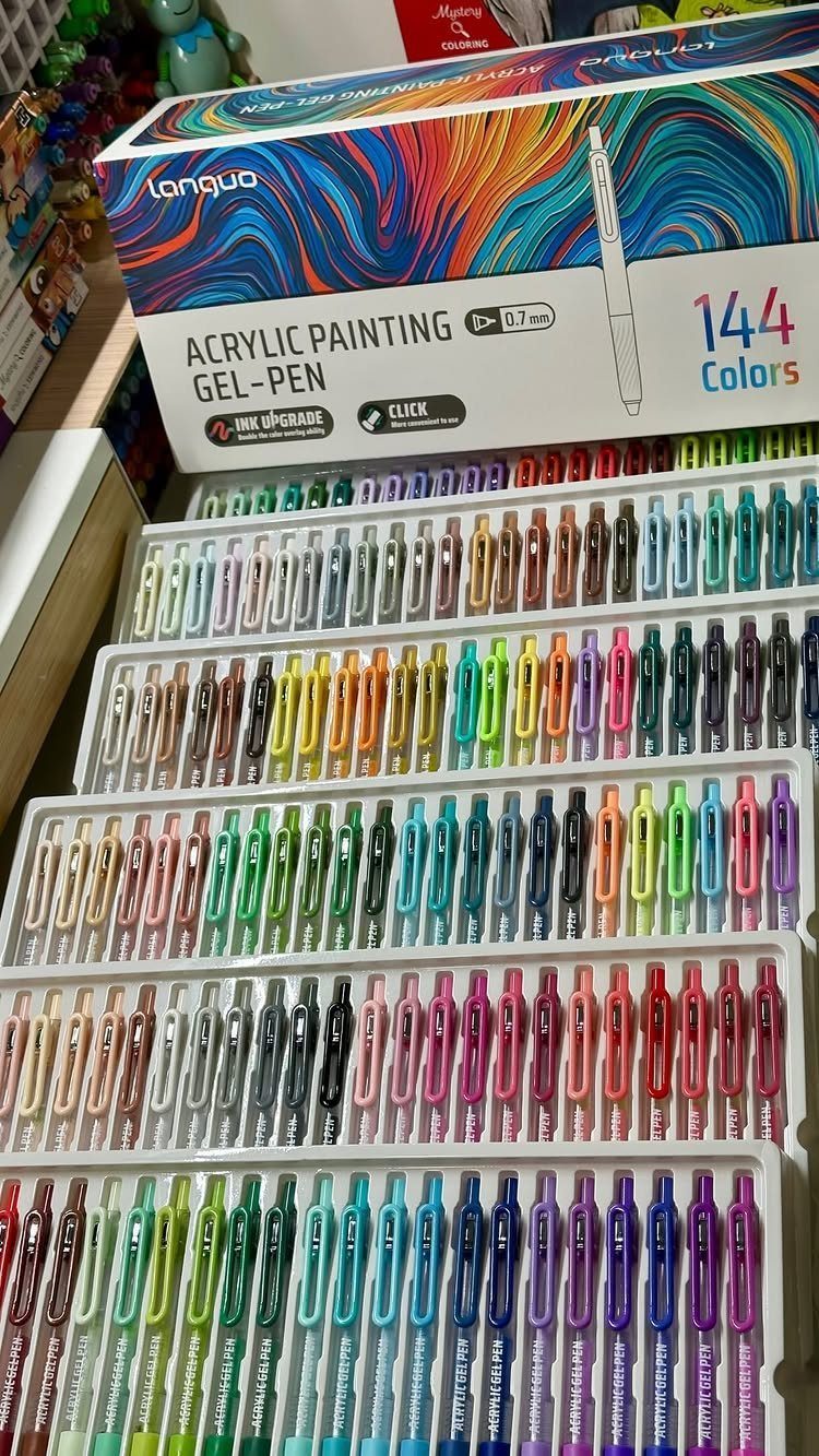 Colorful acrylic painting gel pens organized in trays with their packaging box.