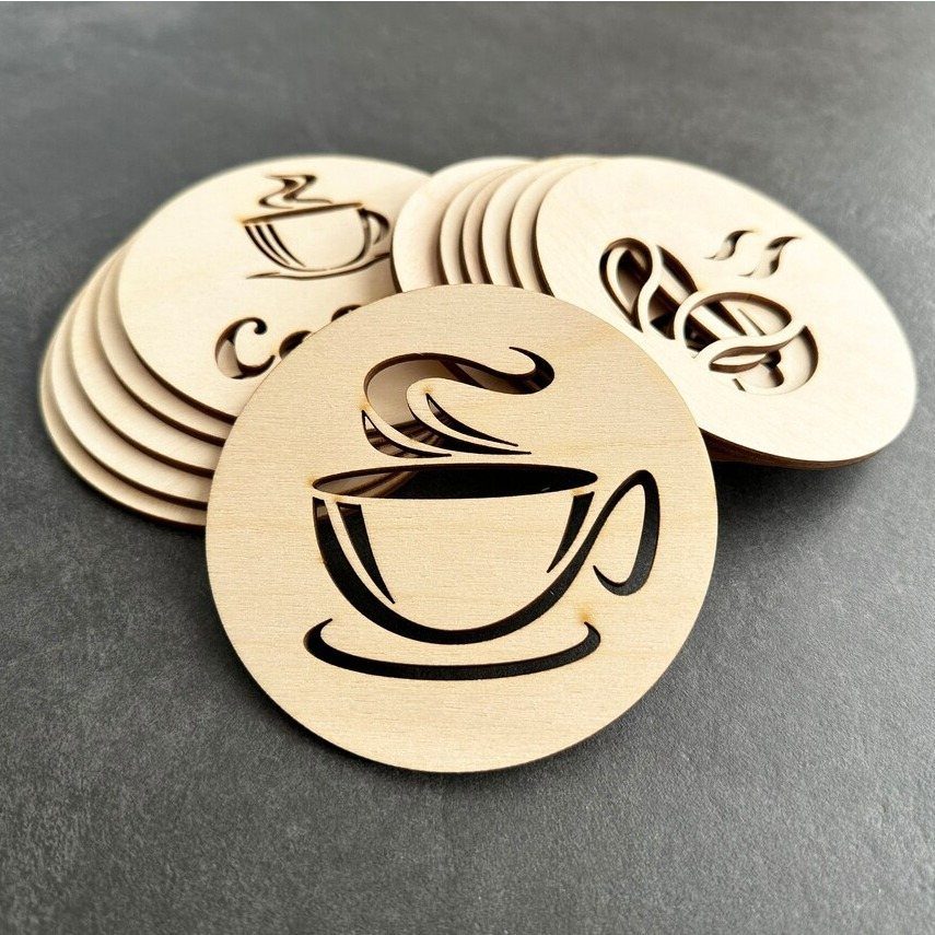 Wooden circular coasters with engraved steaming coffee cup designs on dark grey background