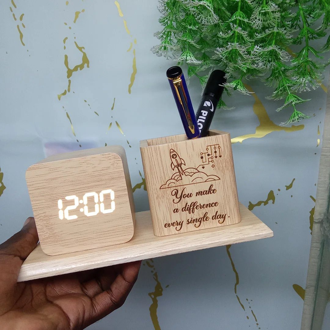 Wooden desk organizer with a digital clock and pen holder held by a hand