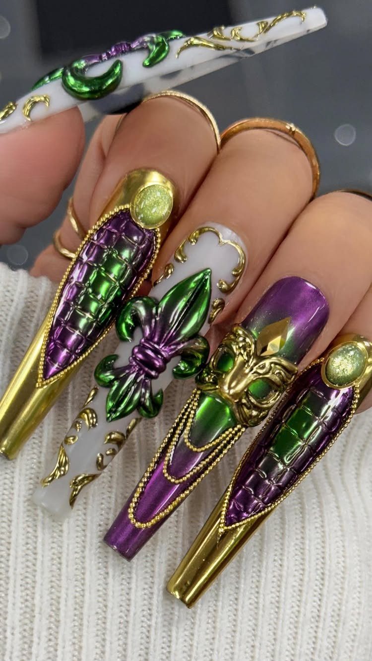 Long stiletto nails with 3D green fleur-de-lis and gold mask Mardi Gras designs.