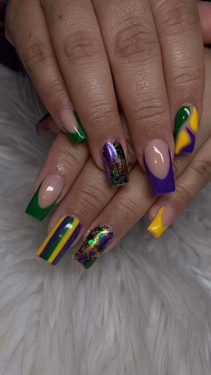 Long square nails painted in purple, green, and gold Mardi Gras colors.