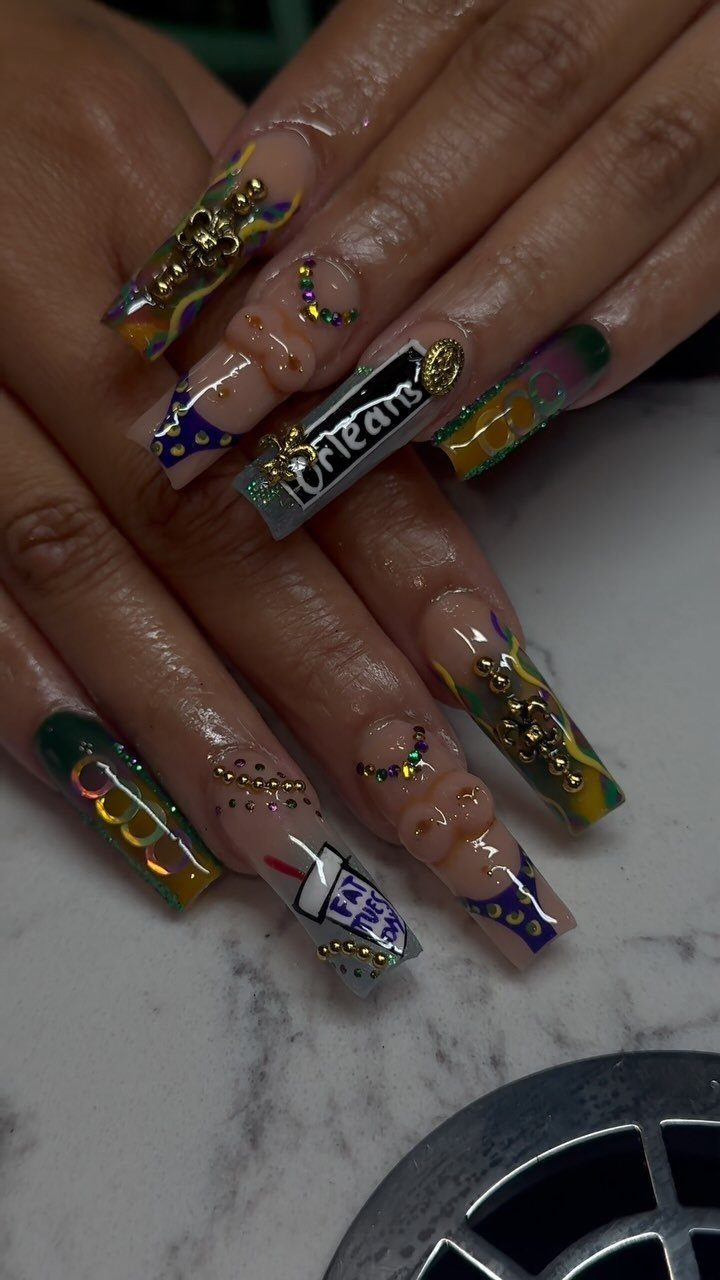 Long coffin nails with purple, green, and gold Mardi Gras themed nail art.