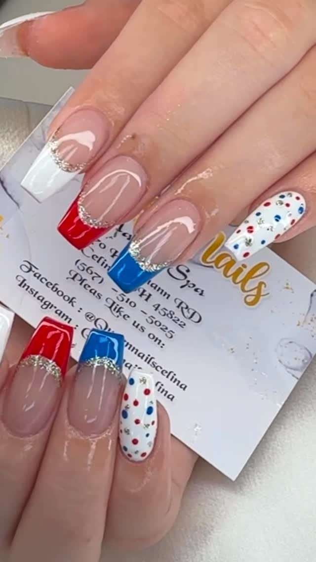 Long coffin nails with red, white, and blue French tips and glitter accents.