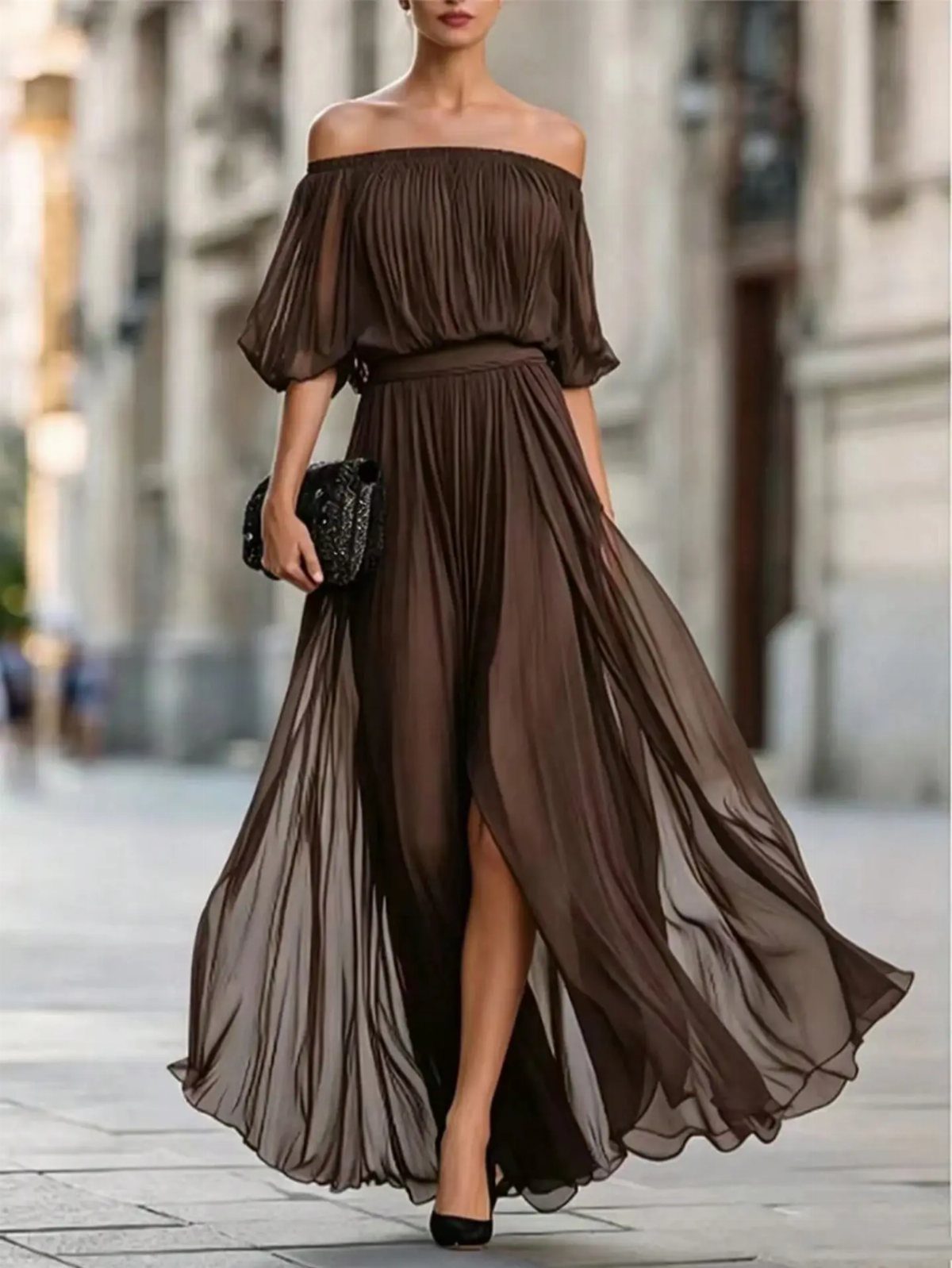 Woman in a flowy caramel brown off-the-shoulder maxi dress on a city street.