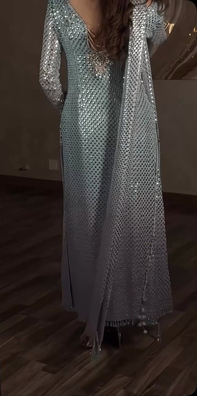 Silver sequined long sleeve maxi dress with a matching shimmering cape and wrap.