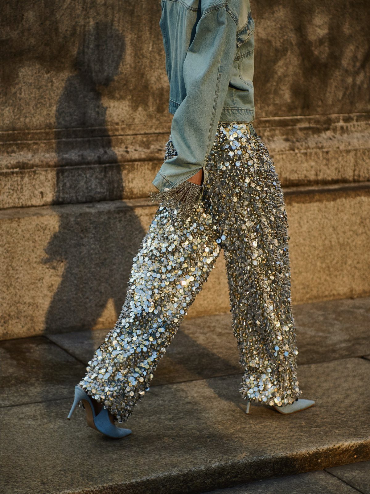 Silver sequined wide-leg pants paired with a denim jacket and blue high heels.
