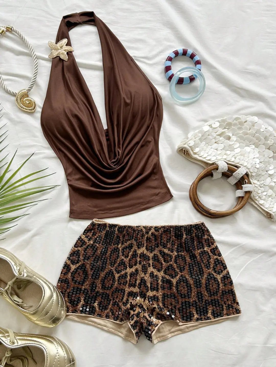 Brown halter top and leopard print sequined shorts with gold shoes and accessories.